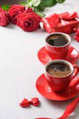 Valentine's day dating with coffee, red chocolate sweets and roses on white. Close up. Romantic date for two. Vertical greeting card.