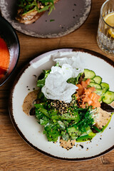 asian salad with salmon on a wooden background