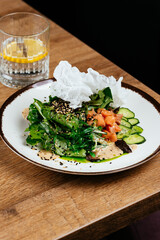 asian salad with salmon on a wooden background