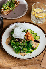 asian salad with salmon on a wooden background