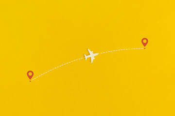 Toy airplane on a yellow background. Top view. Flat lay.