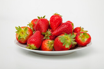 strawberries in a plate on a white background