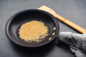 Toasted Sesame Seeds in a Small Skillet: Sesame seeds that have been toasted to a golden brown color