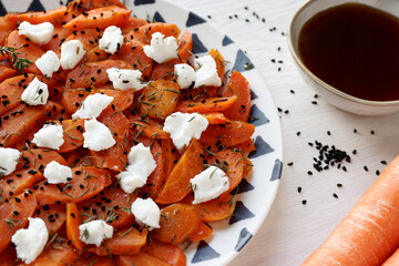 Roasted carrot with white goat cheese, thyme herb, nigella seeds and maple syrup glaze. Sliced...