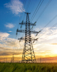 silhouette of high voltage power lines against a colorful sky at sunrise. © yelantsevv