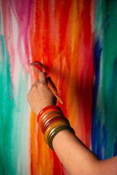 Woman's hand with bangles painting 