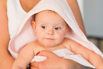 Mom and baby. The baby is wrapped in a towel after the bath.	