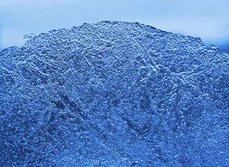 Closeup texture of natural ice on glass background