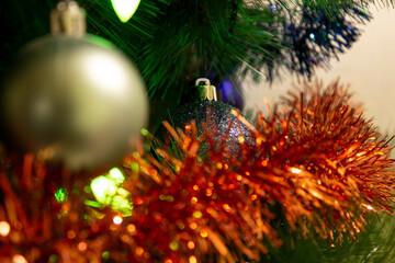 Blue ball on Christmas tree with a garland. High quality photo.