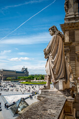 Statue looking down at the Square of Louvre Palace, Paris