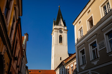 Fototapeta premium Trebon, South Bohemia, Czech Republic, 9 October 2021: observation tower of old town hall at main Masarykovo square, picturesque street with colorful renaissance, baroque and gothic buildings
