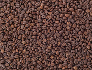 Full frame of coffee beans, abstract background.