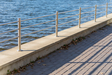 Metal fence railings on the pond embankment