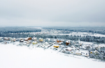Aerial view of the winter landscape. White fields of suburban villages