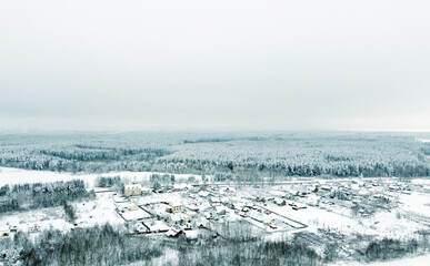 Aerial view of the winter landscape. White fields of suburban villages