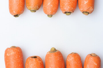 Two lines of carrots on white background. Food concept