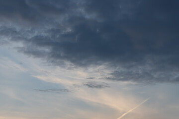 Naklejka na ściany i meble cloudy sky background in summer sunset light