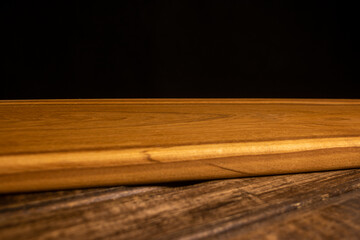 Cutting wooden board on a dark background