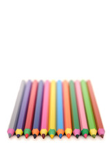 Naklejka premium colored wooden pencils on white background