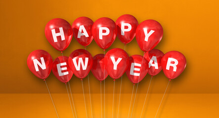Red happy new year balloons on orange concrete background. Horizontal banner