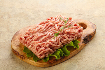 Raw minced pork meat over board