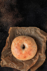 Healthy organic whole grain bagel. Dark background. Top view with copy space. 