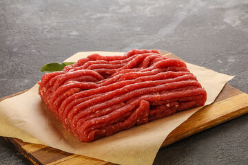 Raw beef minced meat over board