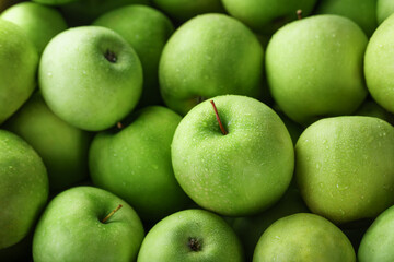 Background of ripe and juicy green apples, perspective from above.