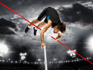 Professional pole vaulter training at the stadium at night