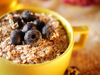 Breakfast of oats and blueberries close up shot 