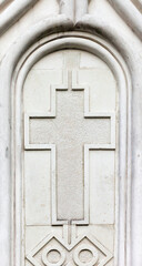 Christian cross on building wall.