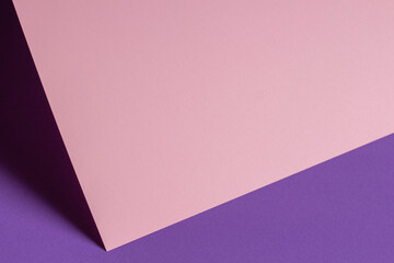 Blank pastel pink paper sheet card note with shadows on violet purple background. Abstract geometric monochrome pink background with copy space for text. Front view