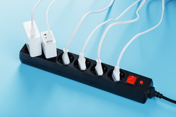 A black mains filter with electrical outlets inserted into it with white plugs of electrical...