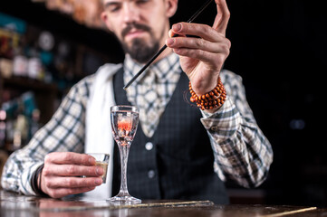 Bartender concocts a cocktail at the saloon