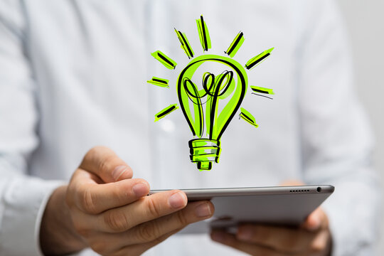 Hands holding green nature in the light bulb