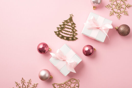 Top View Photo Of Row Composition Christmas Tree Decorations Pink Balls Gold Bell Pine Snowflake Shaped Ornaments White Gift Boxes With Pink Ribbon Bows On Isolated Pastel Pink Background