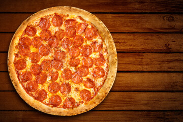 Pizza pepperoni top view. Hot Pizza salami and mozzarella cheese on wooden background for pizzeria banner. Flat lay