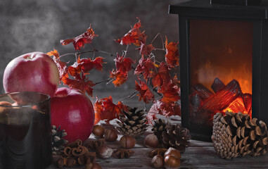 apples, nuts, cones and flame lantern composition