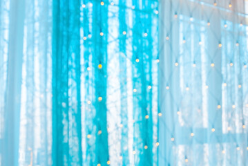 Blurred holiday background. Bokeh background of Christmas garlands. Beautiful New Year's home interior decorations.