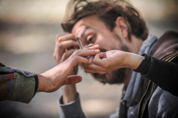 Closeup view of marijuana joint circling around hand to hand