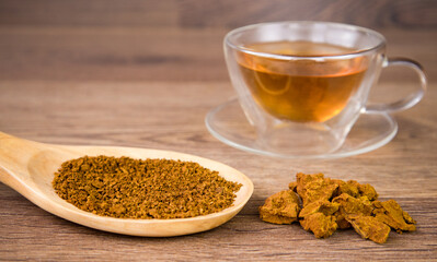 Chaga mushroom a wooden table . A medicinal drink. Healthy pure wild natural chaga mushroom, Inonotus obliquus. 