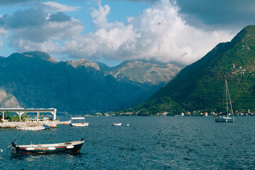 Fototapeta na wymiar View from the boat pier of Perast to the mountain range near the Kotor Bay. Montenegro