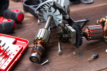 Details of electrical appliance and repair tools on a wooden table in a repair shop