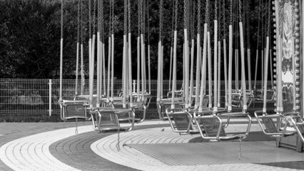 Empty carousel swing in an closed amusement park
