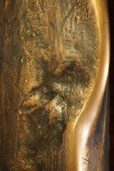 Texture of uneven metal with a wave, bronze close-up