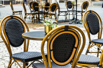 table and chairs at a sidewalk restaurant