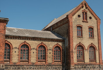 Old brick two-tone building with large windows