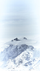 Fototapeta na wymiar Snow covered mountains with clouds