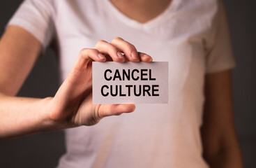 Cancel culture concept. Word on paper in hand.