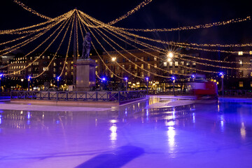 Fototapeta na wymiar Winter in Stockholm. Ice skating in the square in Kungstradgarden. Sweden, Stockholm 